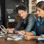 Restaurant managers calculating costs