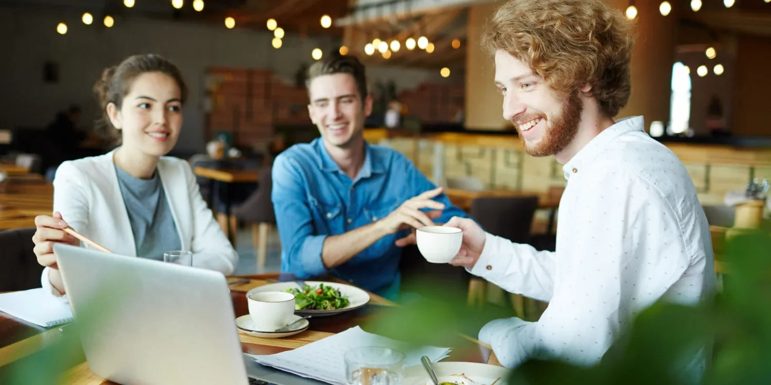 Restaurant staff using a laptop to create website to manage online reservations