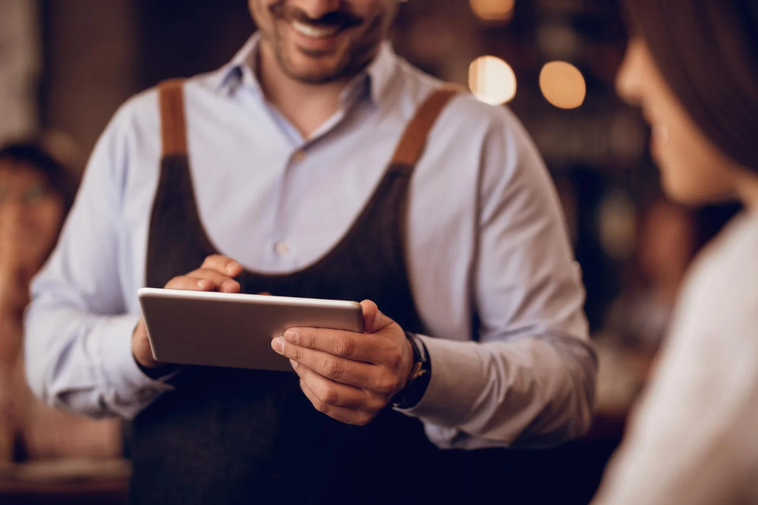 Small restaurant owner managing bookings with limited space and staff