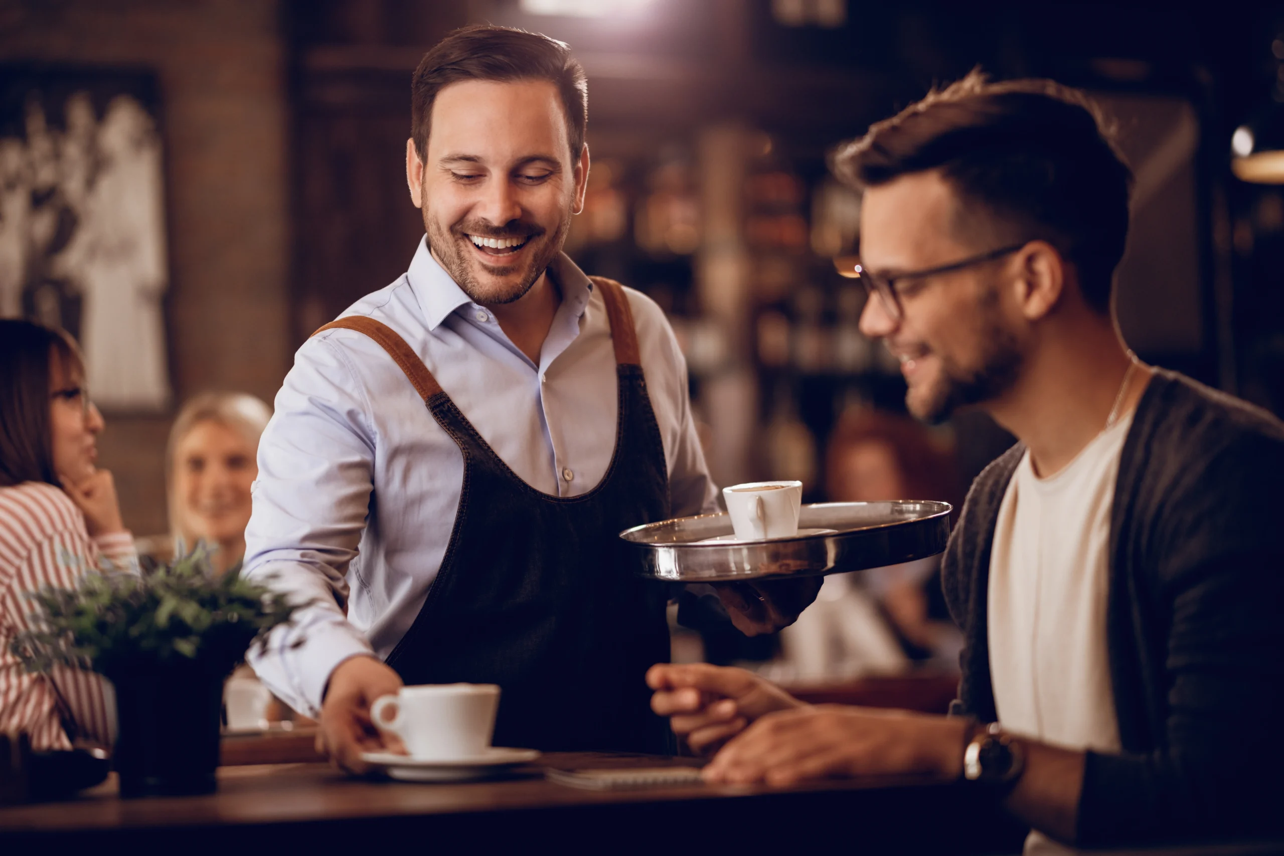happymanservingguestwithcoffeewhileworkingparttimeaswaitercafe 2 | Tableo Service