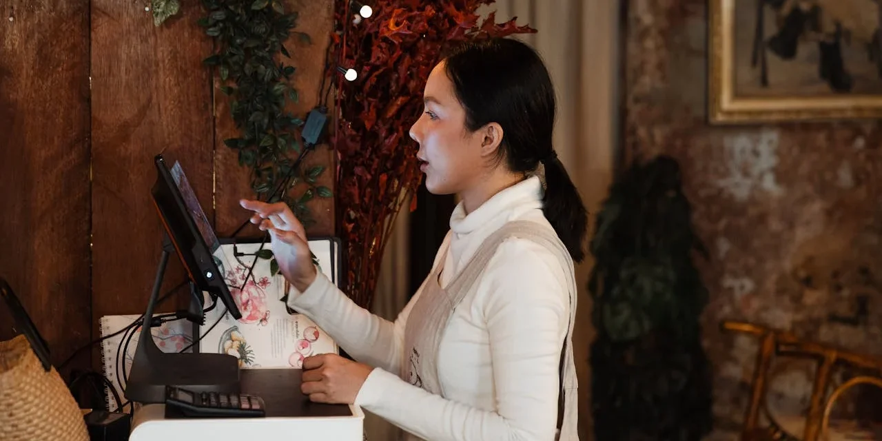 Restaurant manager using a tablet to manage bookings